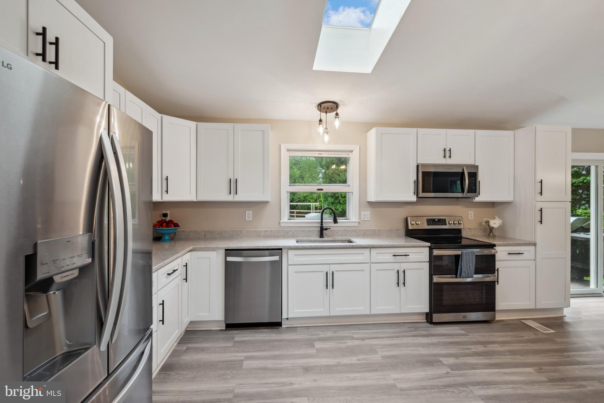 3825 Salem Bottom Road Westminster, MD 21157 - Photo 6 of 43 a kitchen with stainless steel appliances a stove a sink and a refrigerator