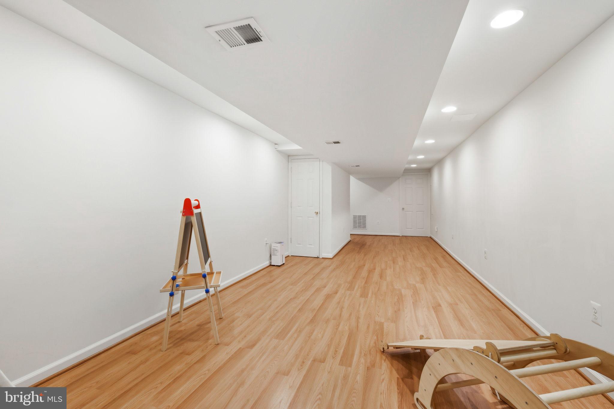 10900 Gainsborough Road Potomac, MD 20854 - Photo 36 of 44 a view of a room with gym equipment and wooden floor