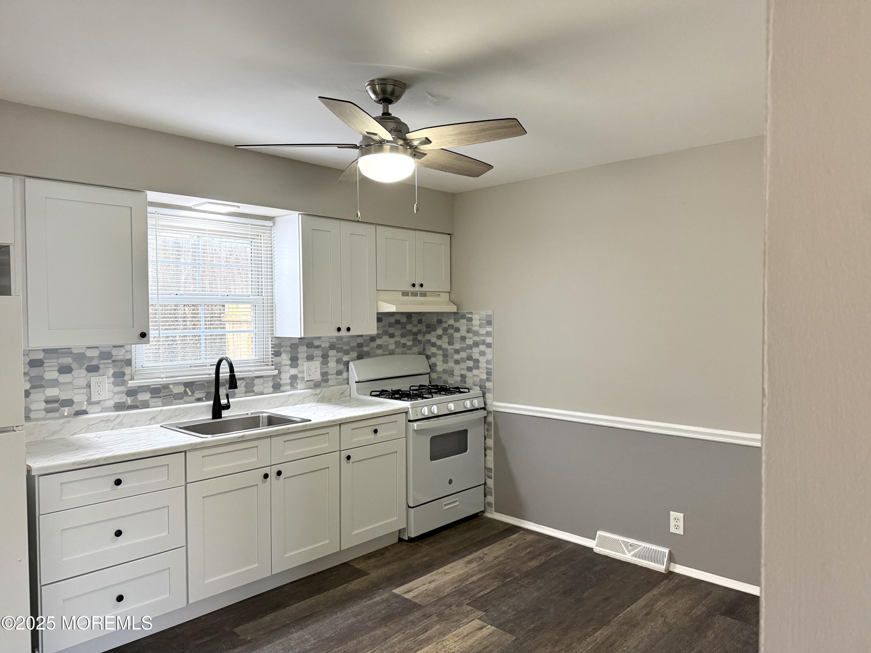 821 Burnt Tavern Road, Unit 6 Point Pleasant, NJ 08742 - Photo 3 of 7 a kitchen with a sink cabinets and window