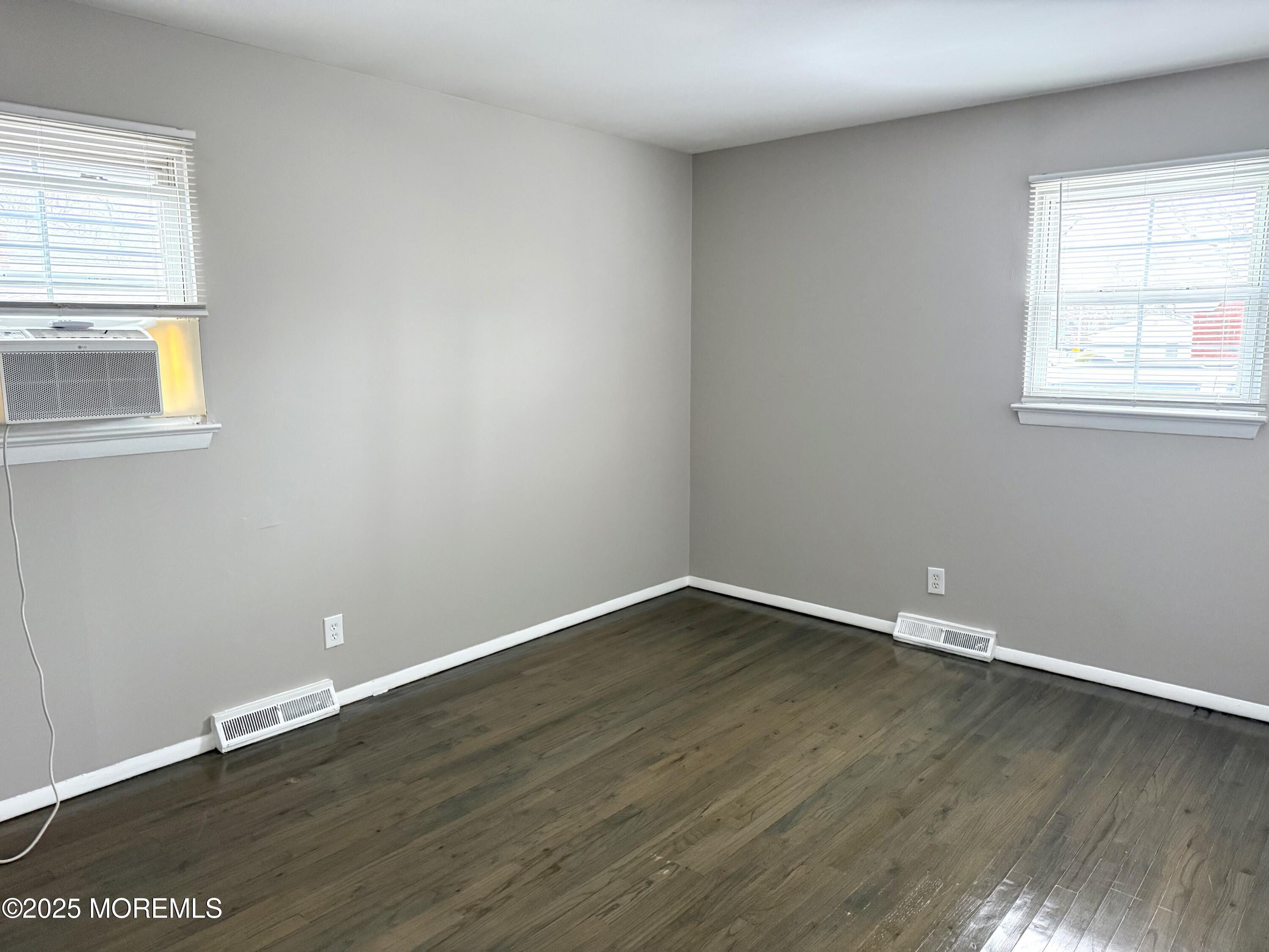 821 Burnt Tavern Road, Unit 6 Point Pleasant, NJ 08742 - Photo 7 of 7 a view of an empty room with wooden floor and a window
