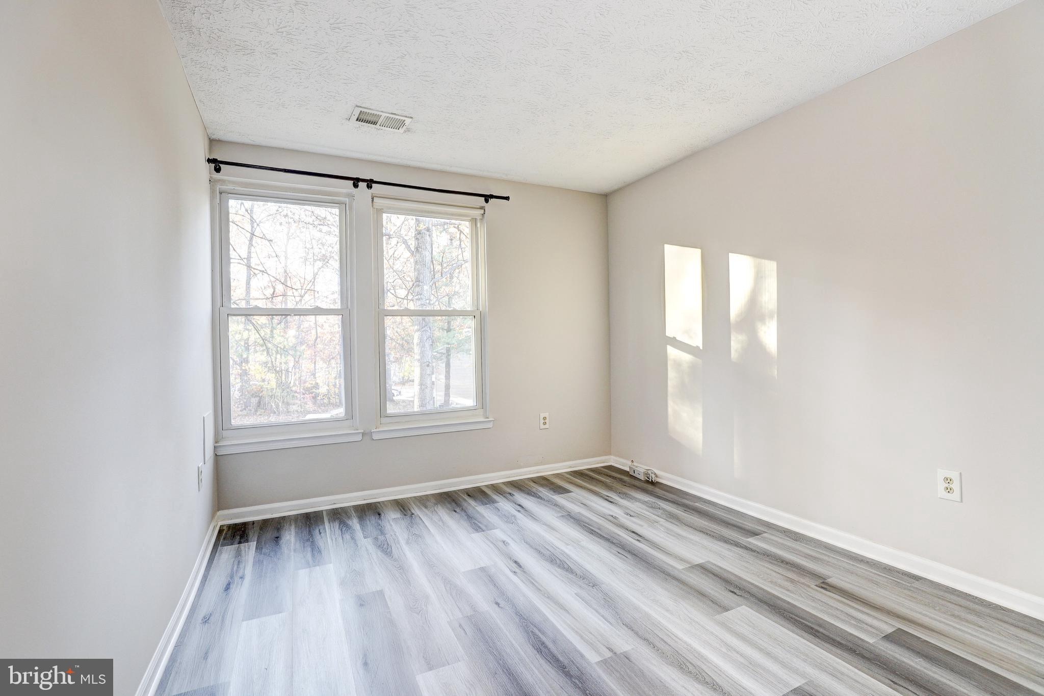 5920 Watch Chain Way, Unit 5106 Columbia, MD 21044 - Photo 12 of 27 an empty room with wooden floor and windows