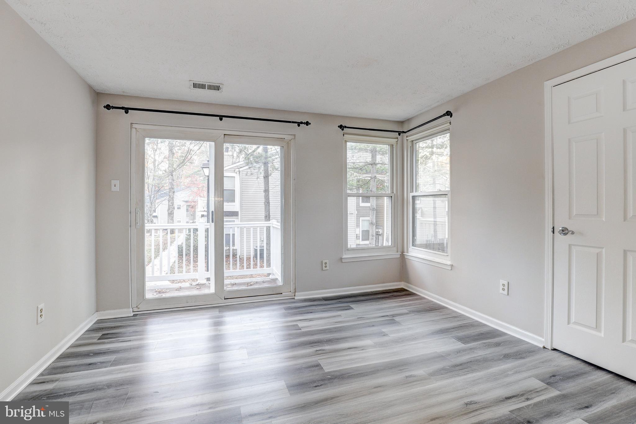 5920 Watch Chain Way, Unit 5106 Columbia, MD 21044 - Photo 14 of 27 a view of an empty room with wooden floor and a window