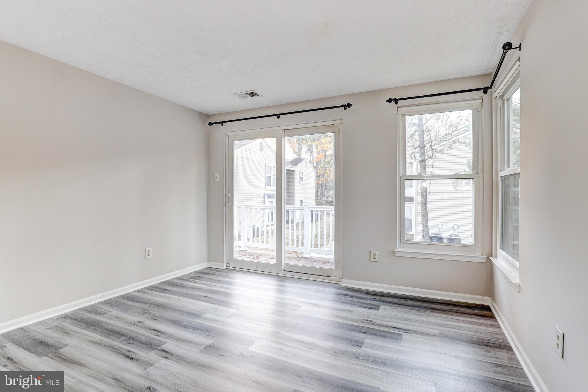 5920 Watch Chain Way, Unit 5106 Columbia, MD 21044 - Photo 15 of 27 a view of an empty room with wooden floor and a window