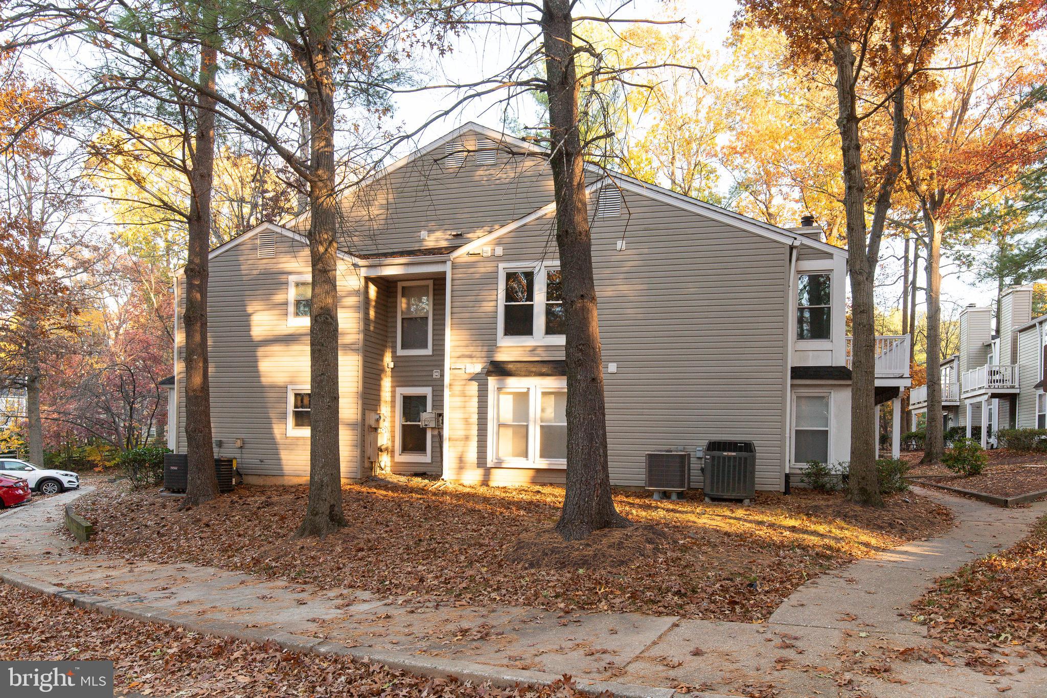 5920 Watch Chain Way, Unit 5106 Columbia, MD 21044 - Photo 23 of 27 a backyard of a house with a large tree