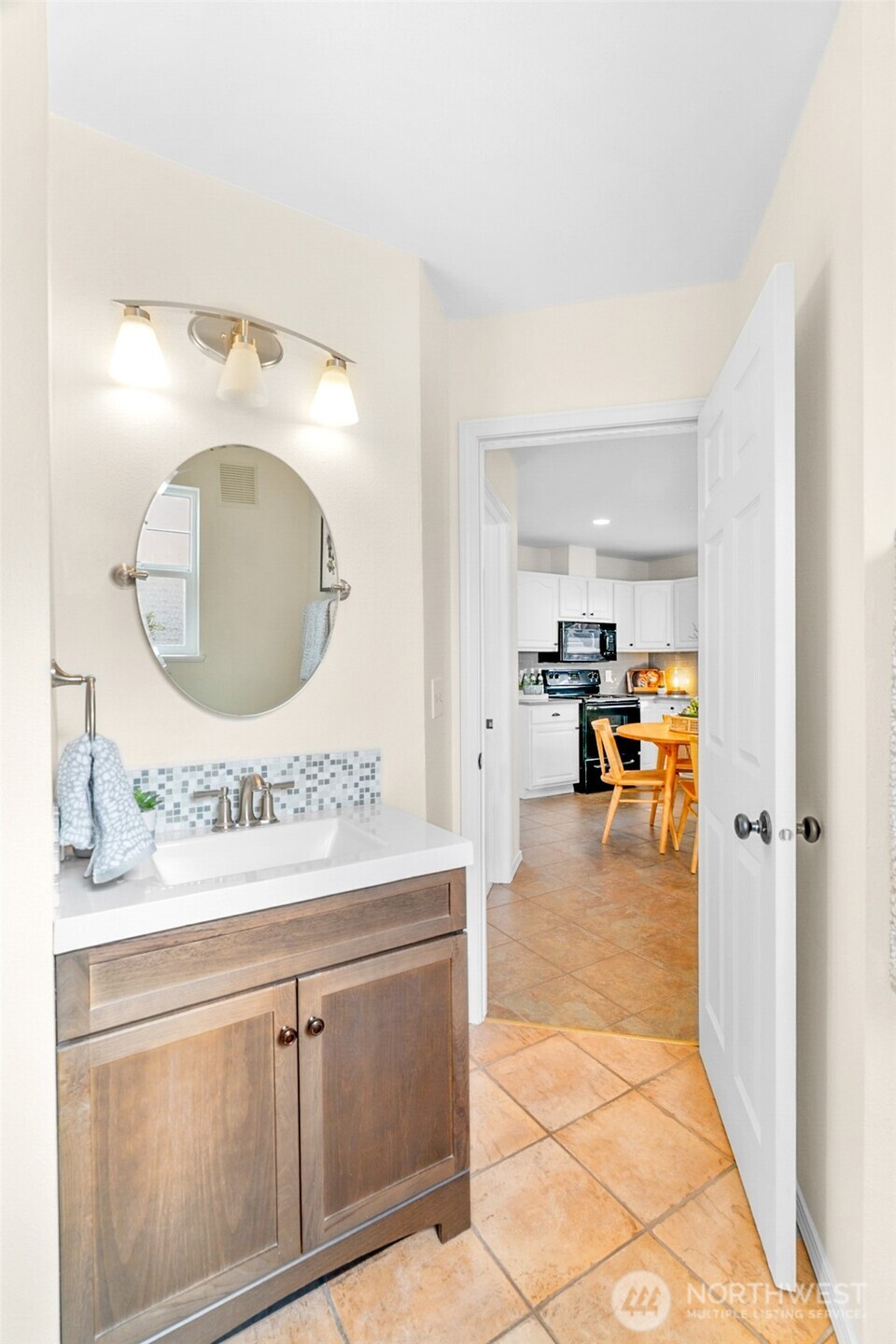 245 Wells Avenue North Renton, WA 98057 - Photo 18 of 26 a en suite bathroom with a double vanity sink and a mirror