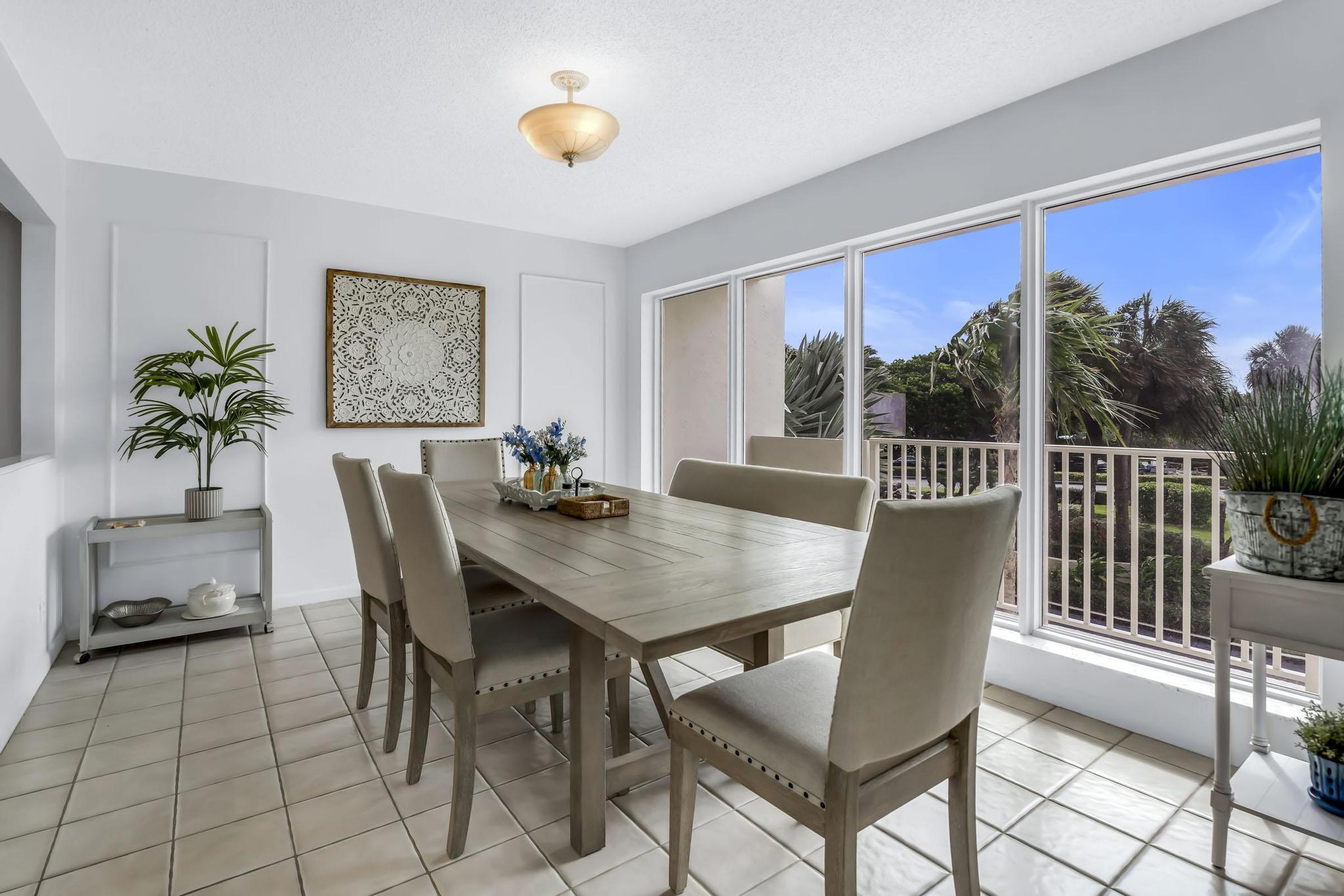 4301 North Ocean Boulevard, Unit A206 Boca Raton, FL 33431 - Photo 11 of 65 a view of a dining room and livingroom with furniture wooden floor and a rug