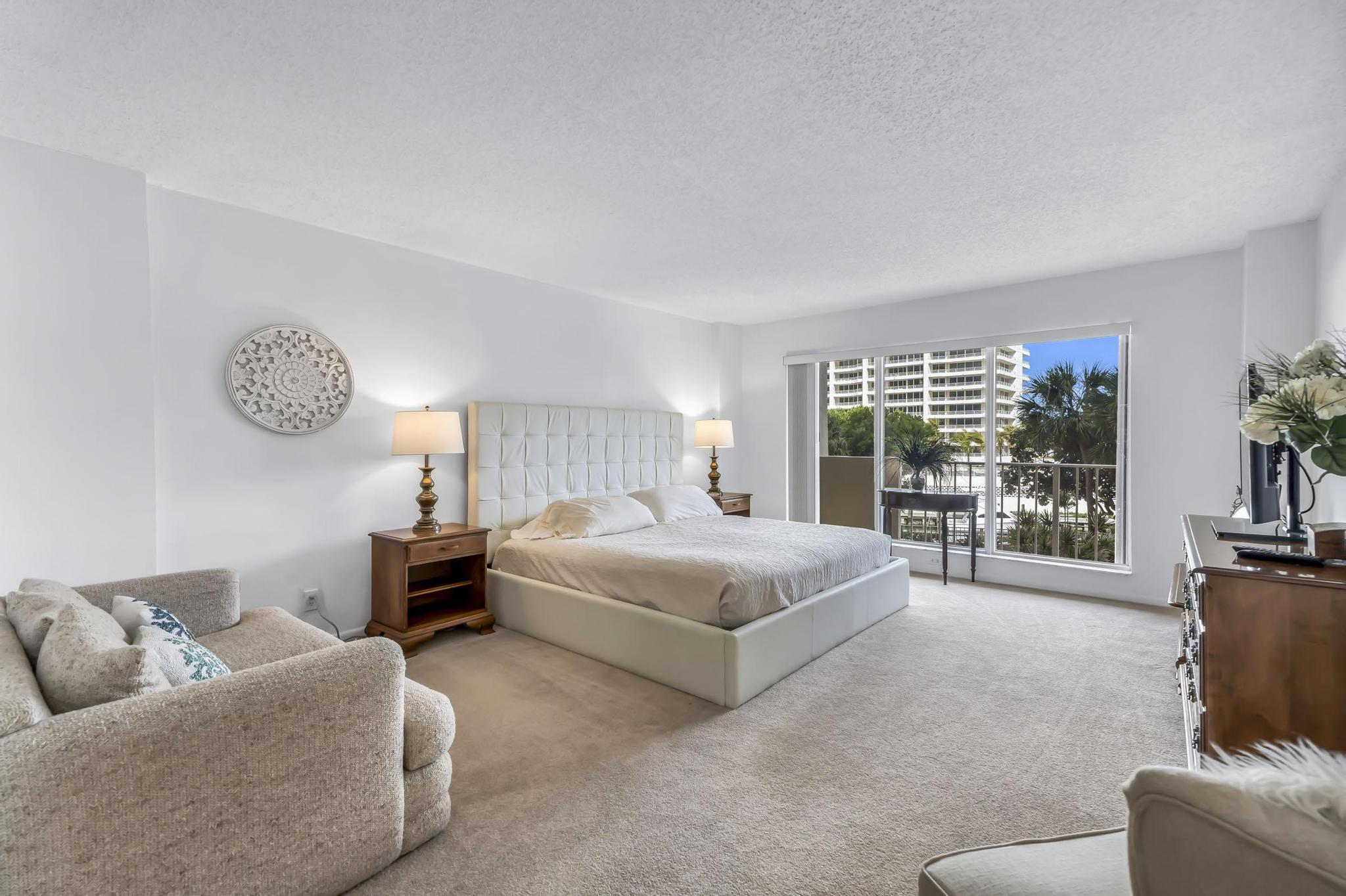 4301 North Ocean Boulevard, Unit A206 Boca Raton, FL 33431 - Photo 20 of 65 a bedroom with a bed couch and large window