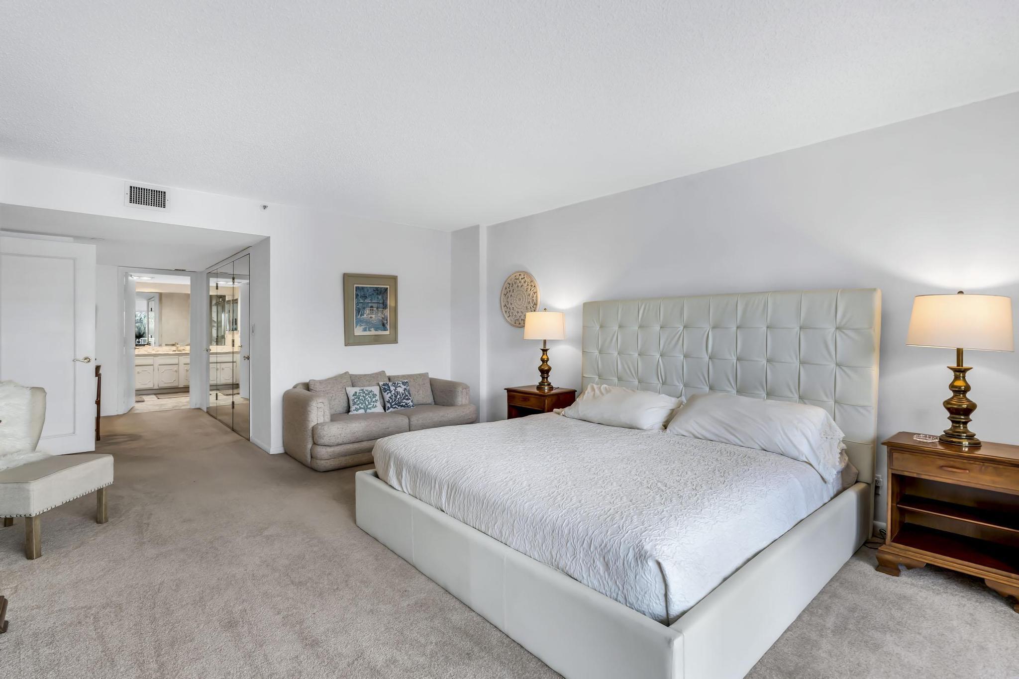4301 North Ocean Boulevard, Unit A206 Boca Raton, FL 33431 - Photo 21 of 65 a bedroom with bed and a couch