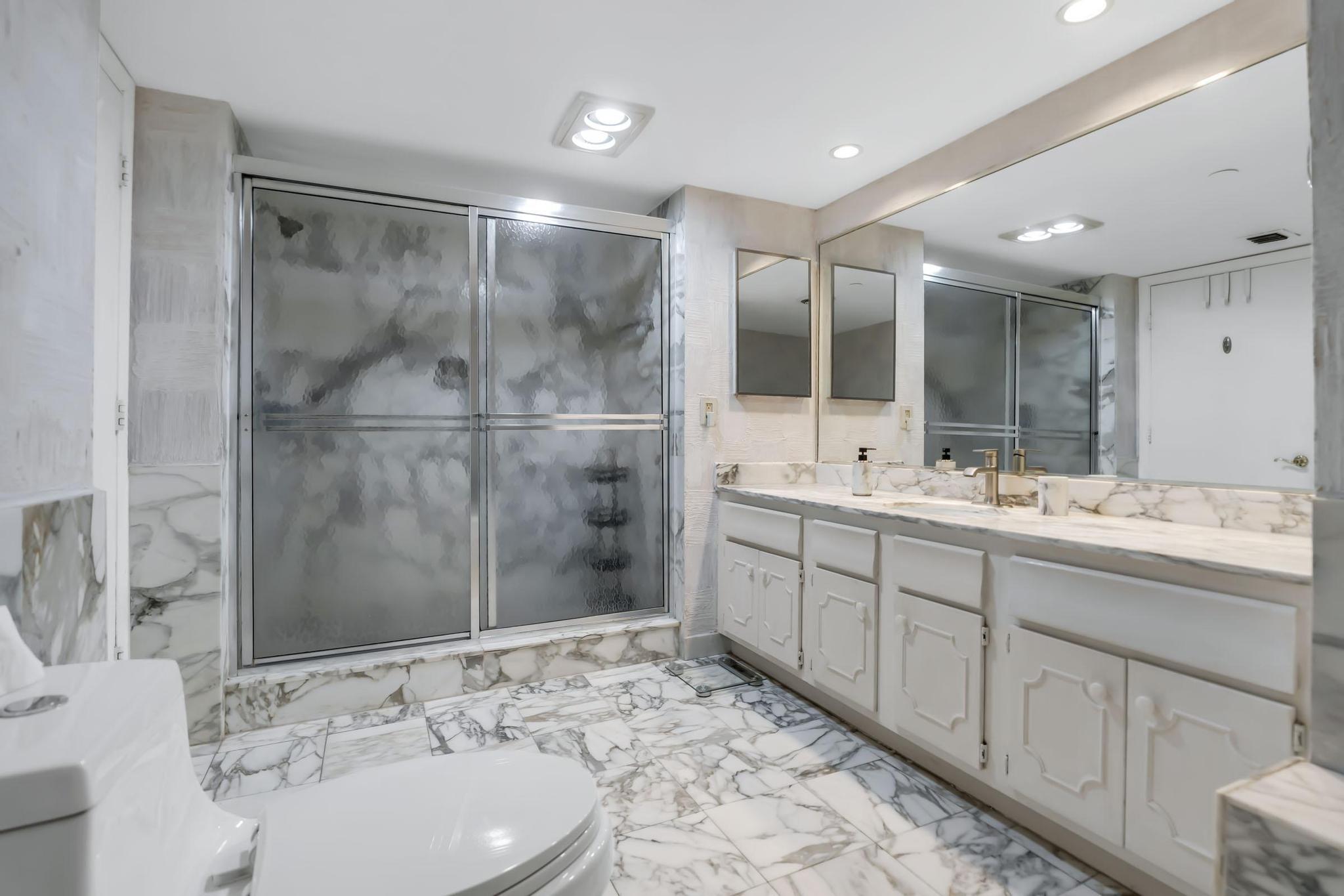 4301 North Ocean Boulevard, Unit A206 Boca Raton, FL 33431 - Photo 27 of 65 a bathroom with a sink and a mirror