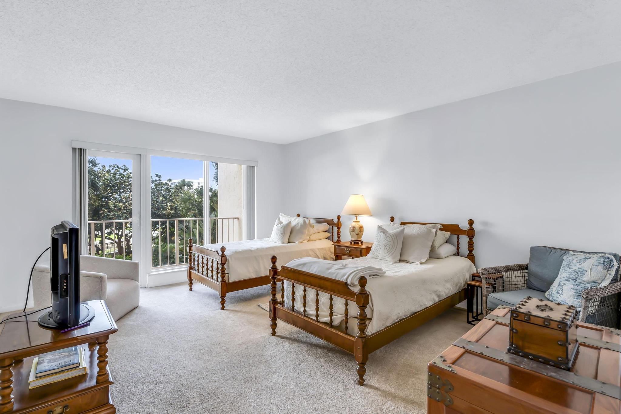 4301 North Ocean Boulevard, Unit A206 Boca Raton, FL 33431 - Photo 30 of 65 a bedroom with a bed and a couch next to a window