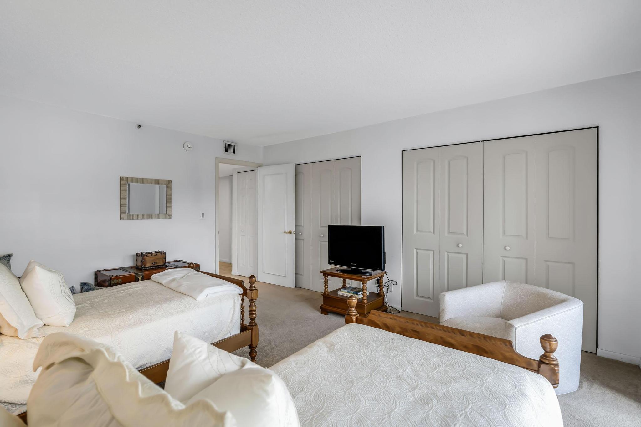 4301 North Ocean Boulevard, Unit A206 Boca Raton, FL 33431 - Photo 31 of 65 a bedroom with a bed and a flat screen tv