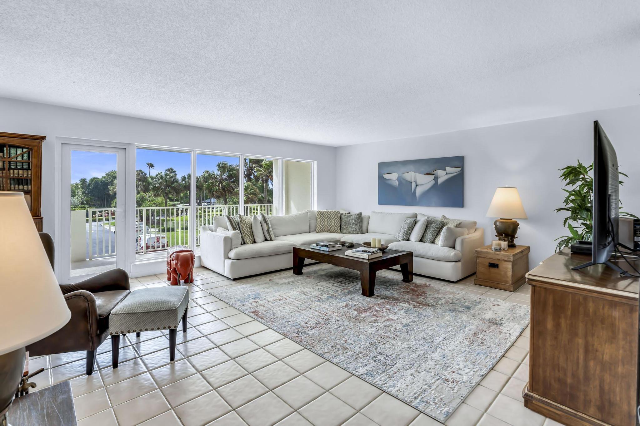 4301 North Ocean Boulevard, Unit A206 Boca Raton, FL 33431 - Photo 4 of 65 a living room with furniture and a potted plant