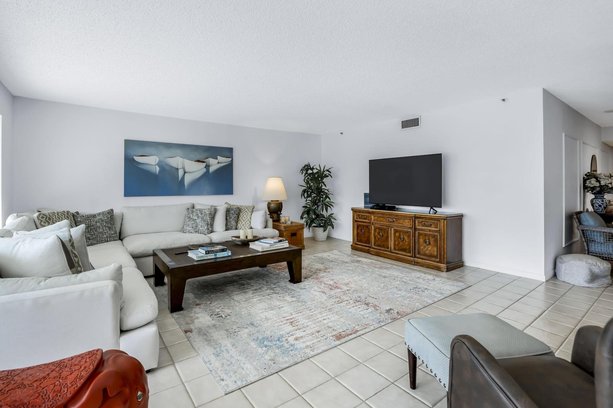 4301 North Ocean Boulevard, Unit A206 Boca Raton, FL 33431 - Photo 5 of 65 a living room with furniture and a flat screen tv