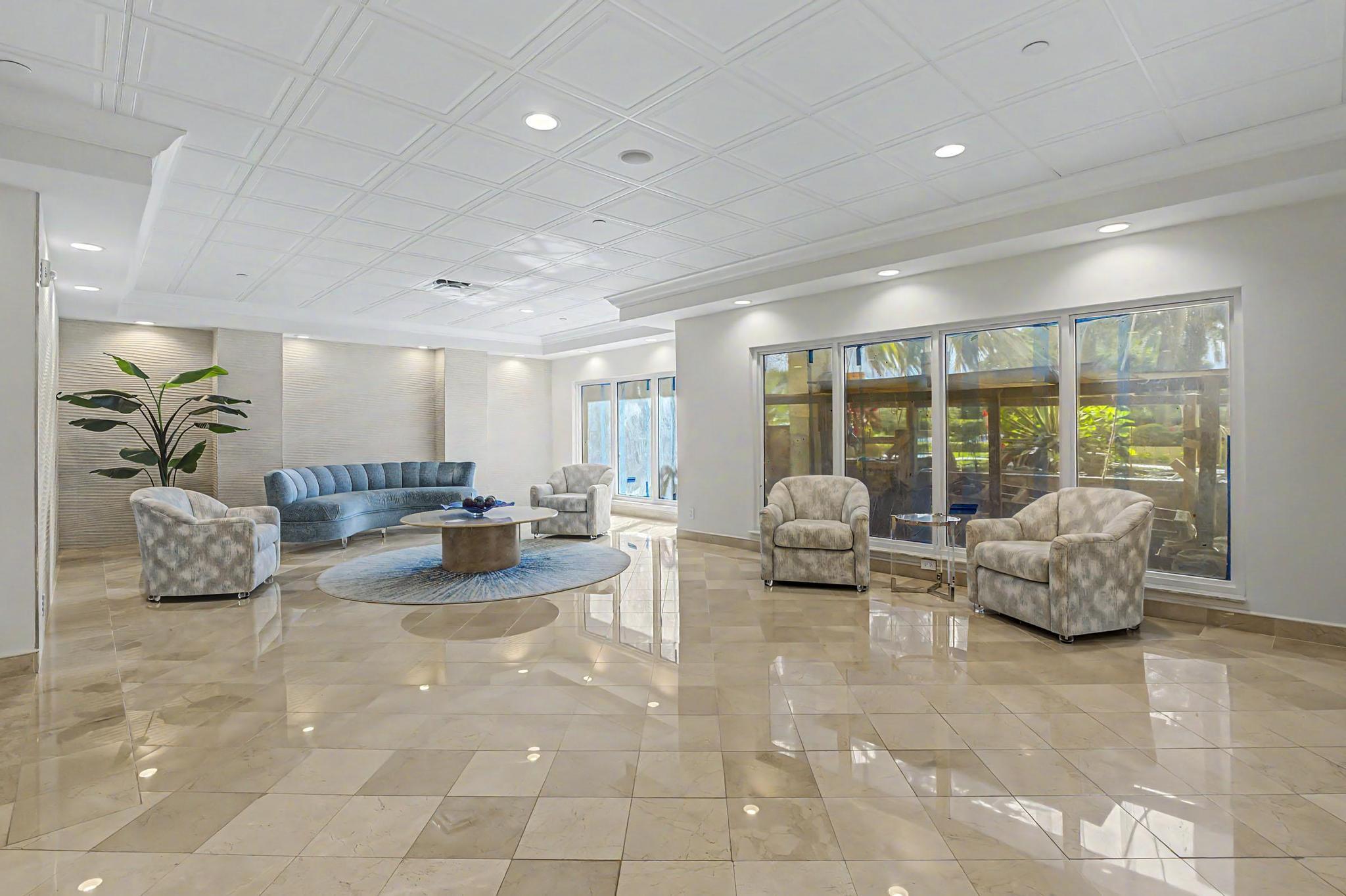 4301 North Ocean Boulevard, Unit A206 Boca Raton, FL 33431 - Photo 52 of 65 a lobby with furniture and floor to ceiling window