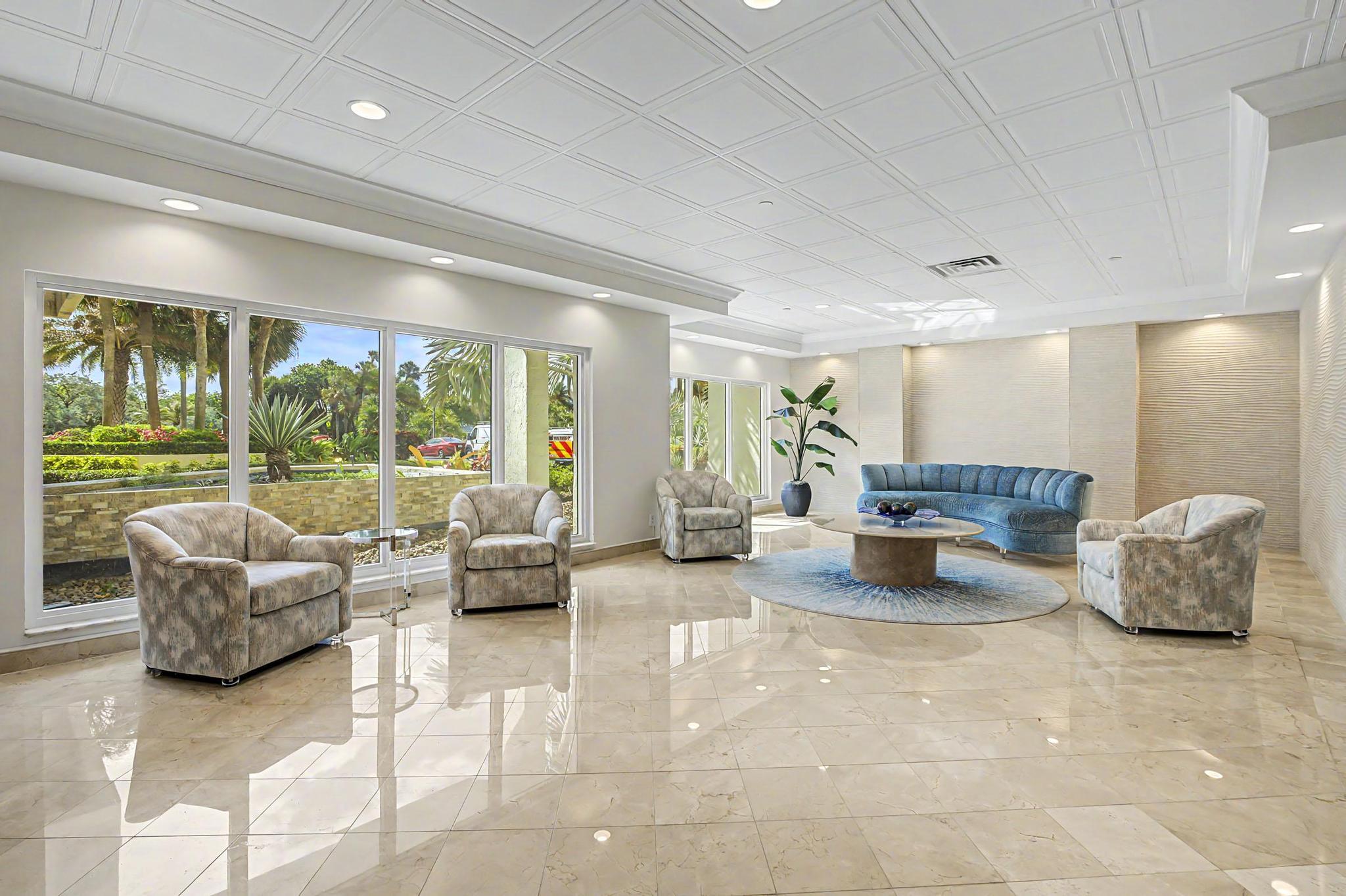 4301 North Ocean Boulevard, Unit A206 Boca Raton, FL 33431 - Photo 53 of 65 a living room with furniture and a large window