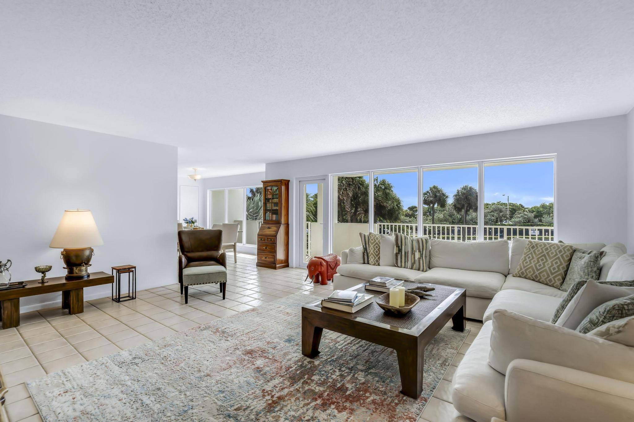 4301 North Ocean Boulevard, Unit A206 Boca Raton, FL 33431 - Photo 6 of 65 a living room with furniture and a lamp