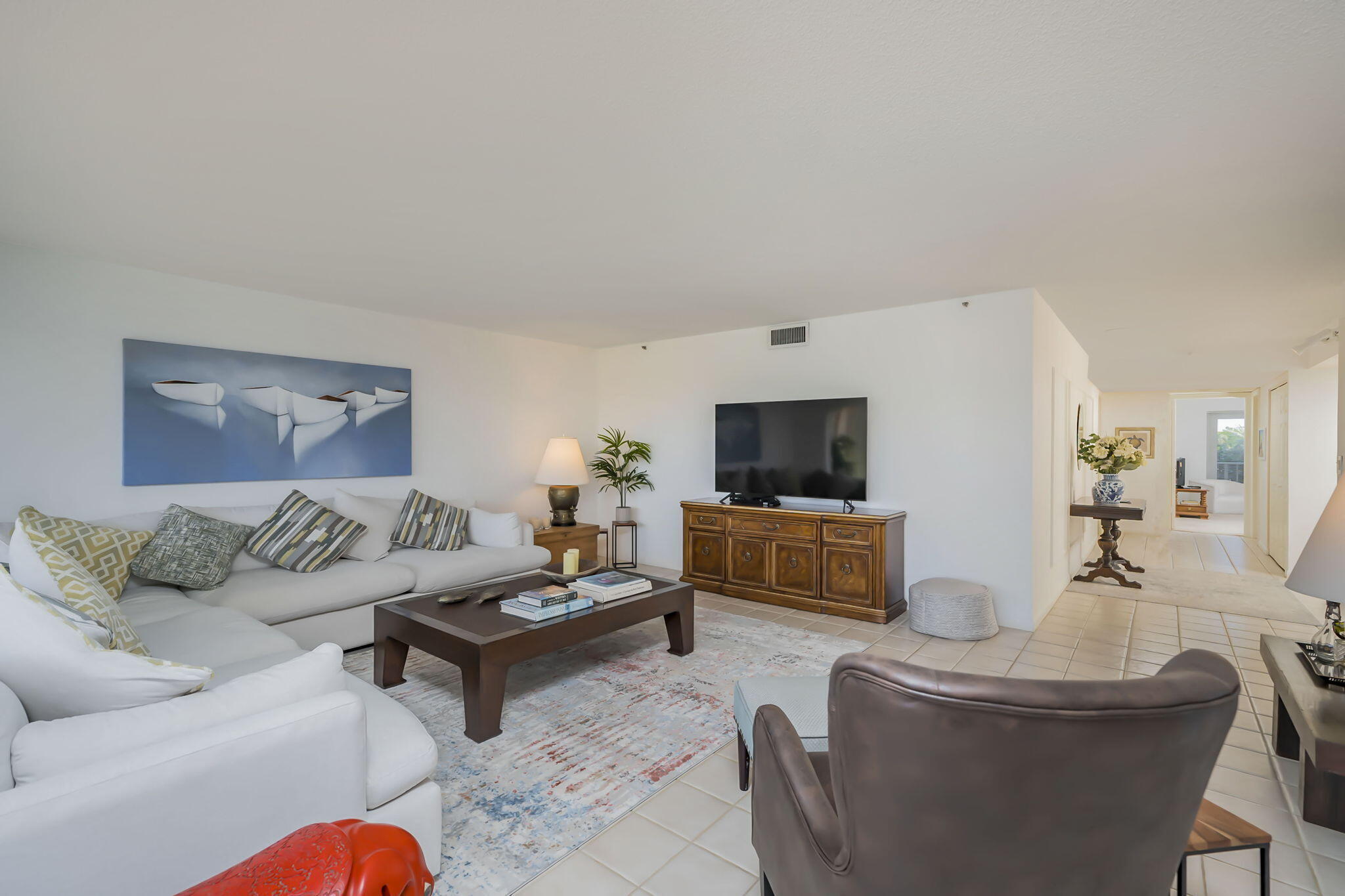 4301 North Ocean Boulevard, Unit A206 Boca Raton, FL 33431 - Photo 10 of 65 a living room with furniture and a flat screen tv