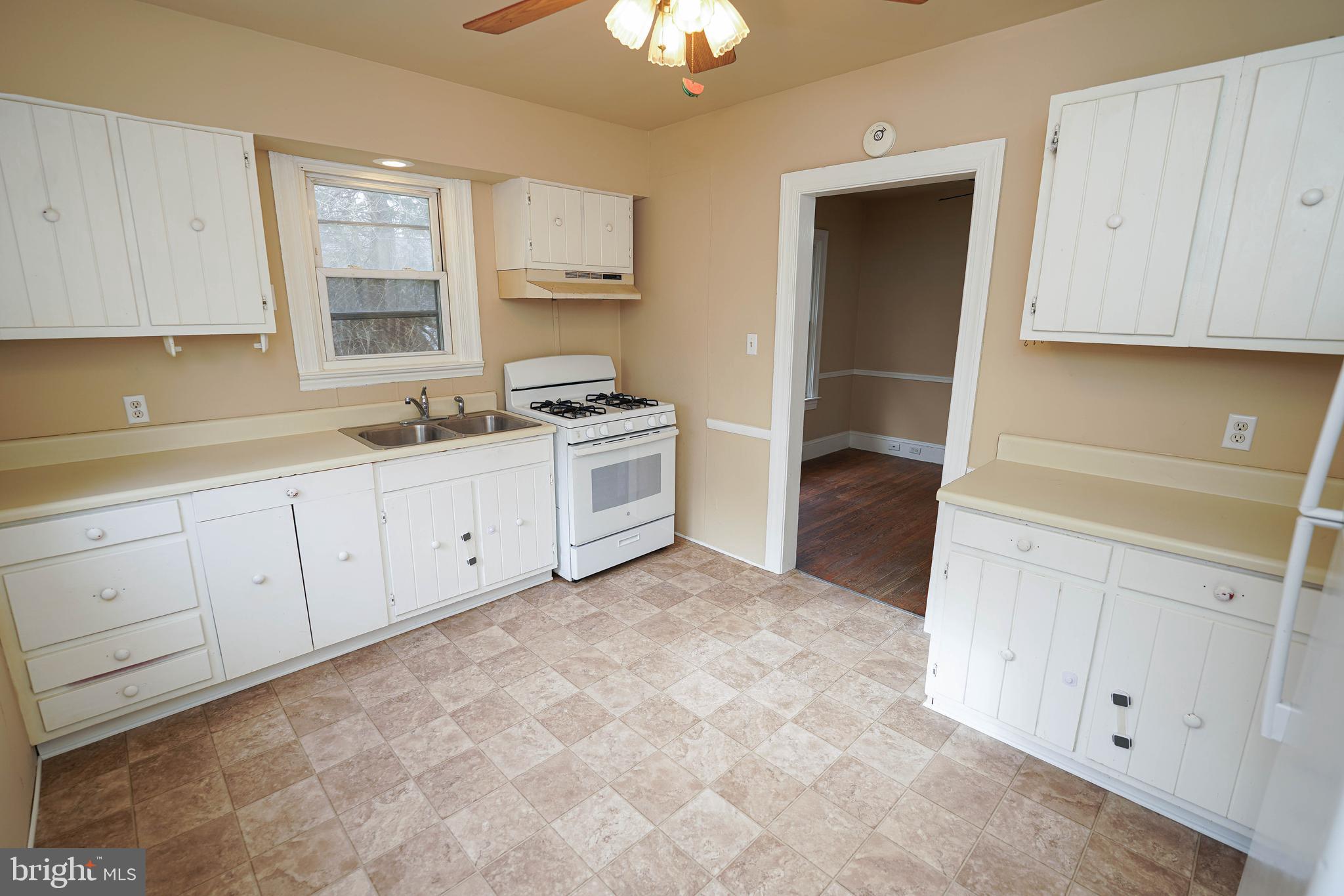 31339 Old Ocean City Road Salisbury, MD 21804 - Photo 18 of 52 a kitchen with white cabinets and sink