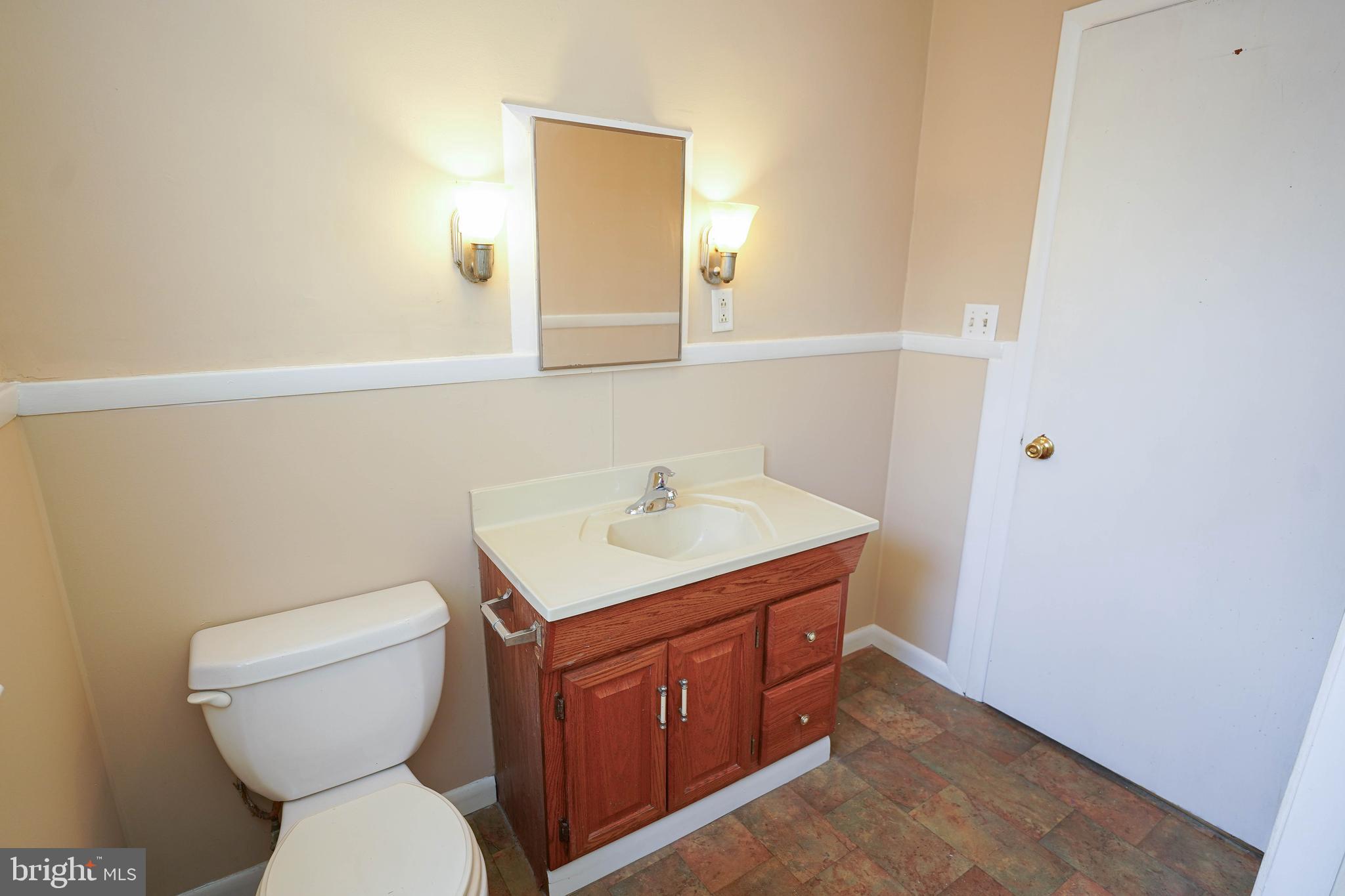 31339 Old Ocean City Road Salisbury, MD 21804 - Photo 34 of 52 a bathroom with a toilet sink and mirror