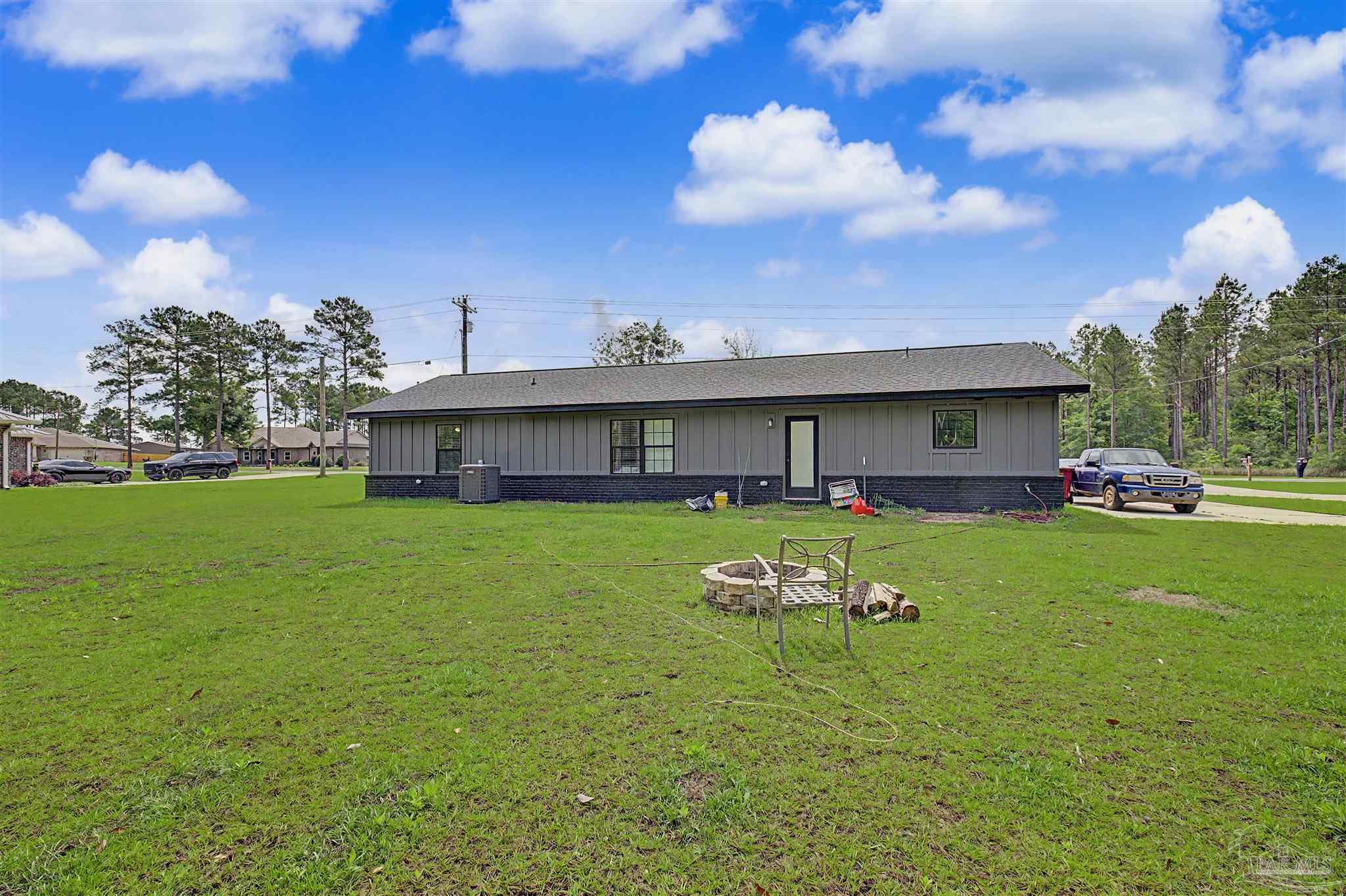 2549 Ten Mile Road Pace, FL 32571 - Photo 41 of 46 a front view of a house with garden