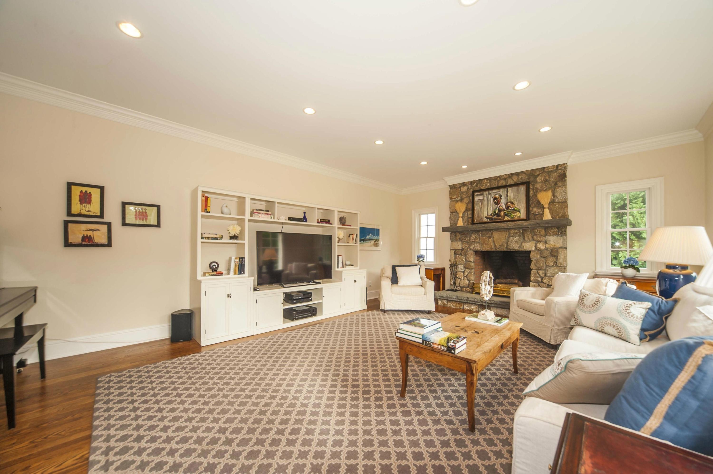 2 Hampton Road Darien, CT 06820 - Photo 11 of 25 a living room with furniture a flat screen tv and a fireplace