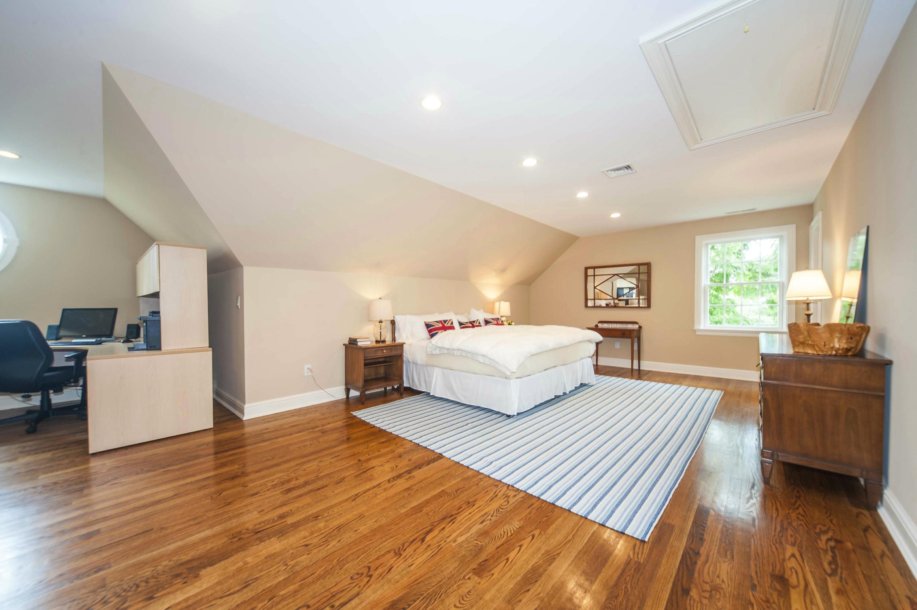 2 Hampton Road Darien, CT 06820 - Photo 24 of 25 a bedroom with a large bed and wooden floor