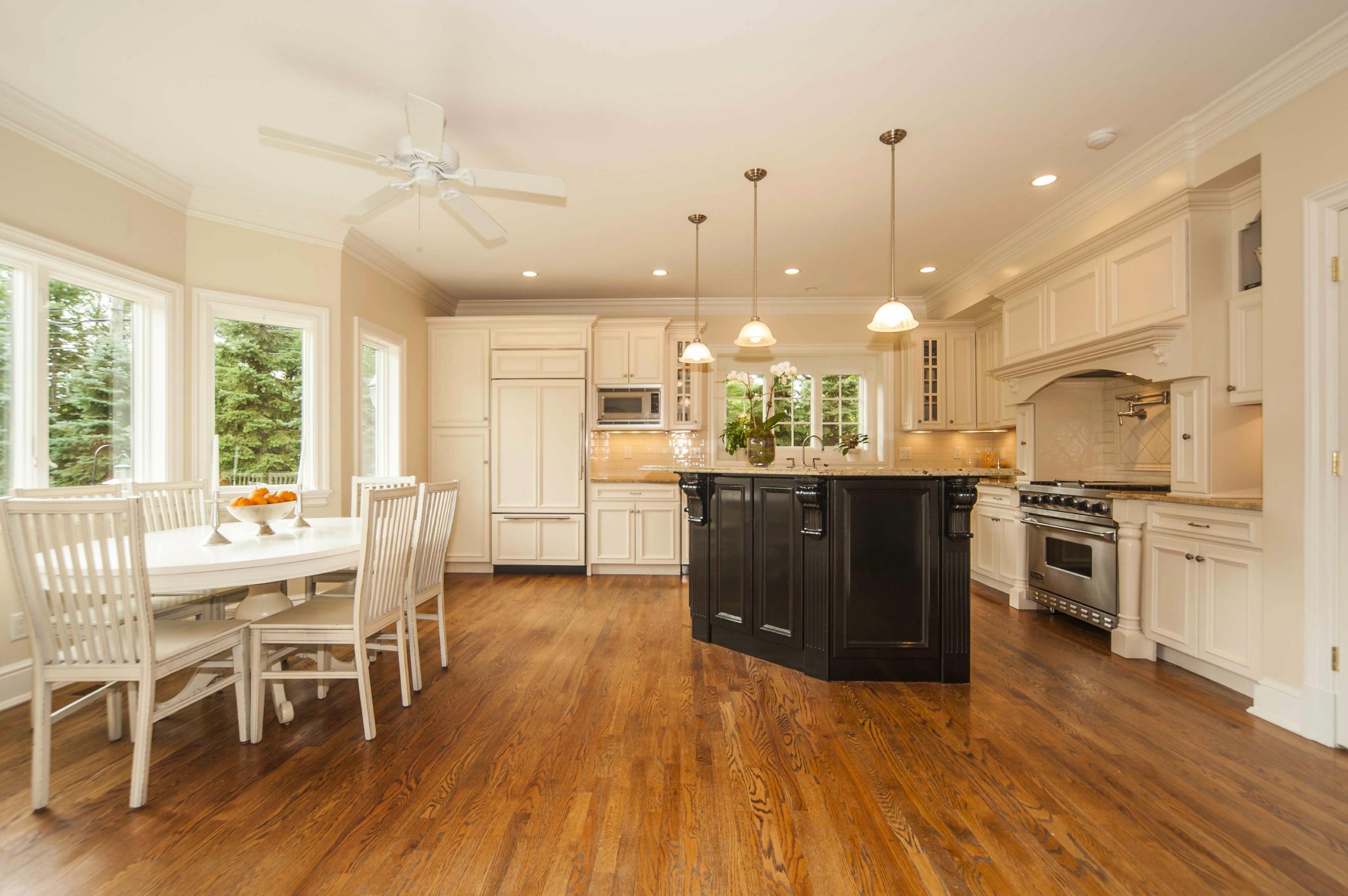 2 Hampton Road Darien, CT 06820 - Photo 8 of 25 a open kitchen with stainless steel appliances granite countertop a stove top oven a sink dishwasher a dining table and chairs with wooden floor