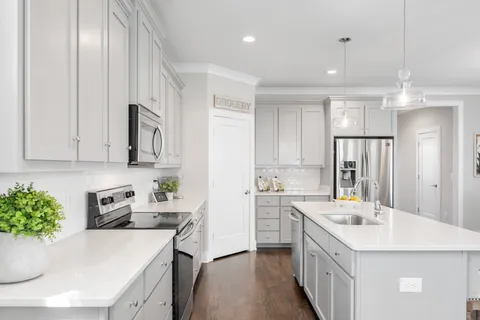 a kitchen with a sink stove and refrigerator