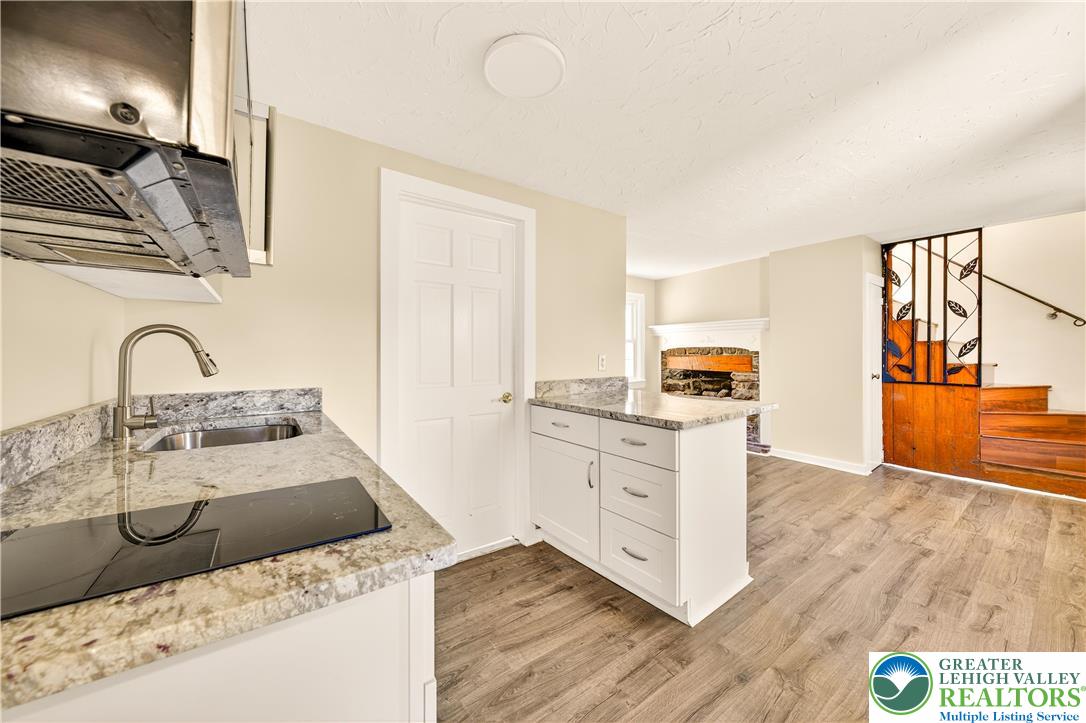 1740 Butztown Road Bethlehem, PA 18017 - Photo 20 of 29 a kitchen with stainless steel appliances granite countertop a sink and a stove top oven with wooden floor