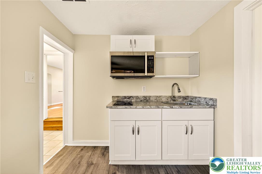 1740 Butztown Road Bethlehem, PA 18017 - Photo 22 of 29 a kitchen with granite countertop a sink and a stove top oven