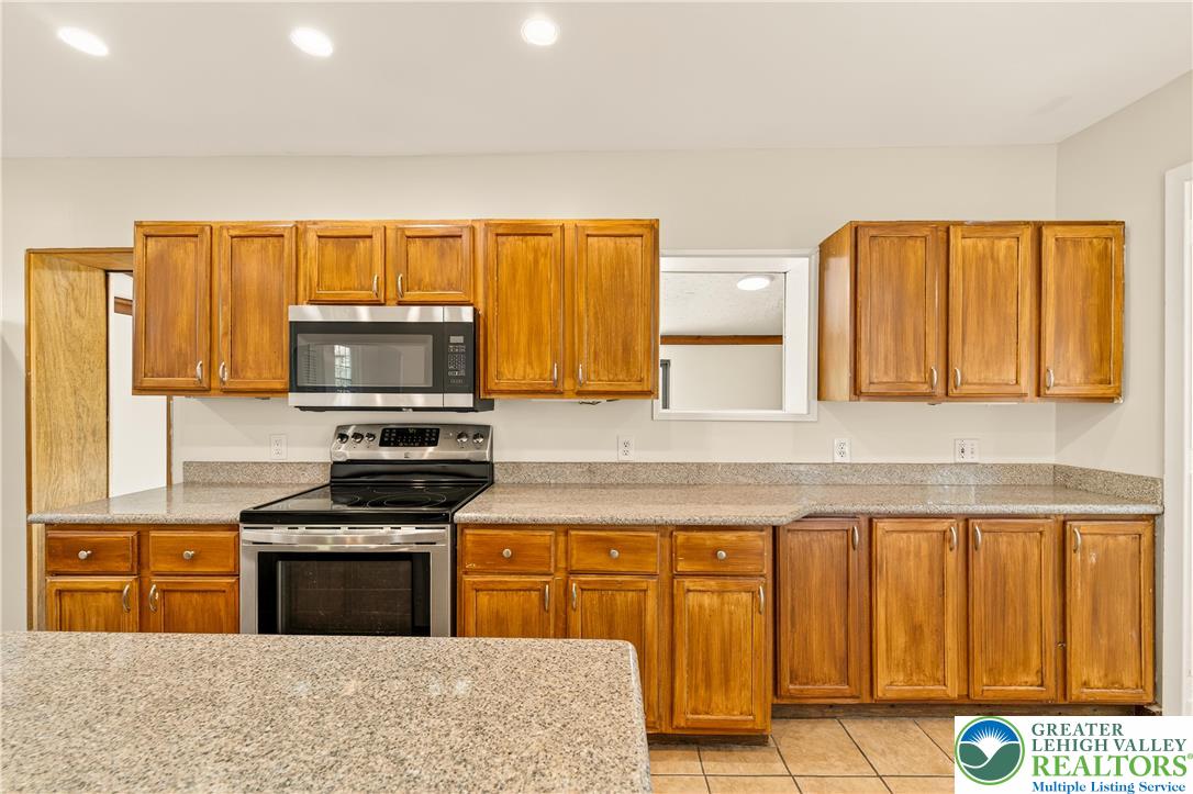 1740 Butztown Road Bethlehem, PA 18017 - Photo 4 of 29 a kitchen with stainless steel appliances granite countertop a stove a sink and a microwave