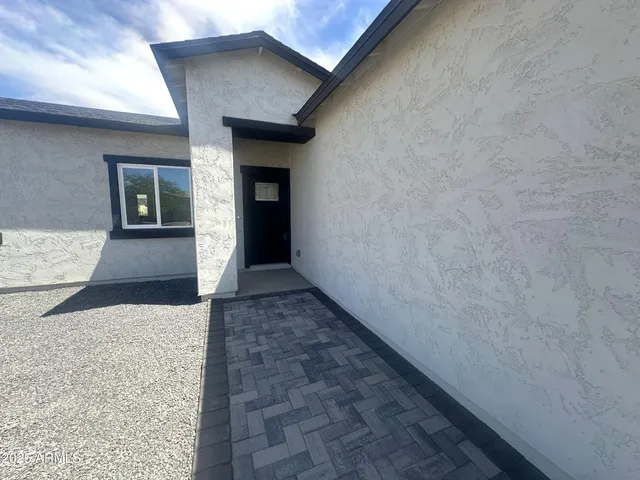 a view of a pathway both side of house