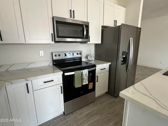 a kitchen with a refrigerator stove and microwave