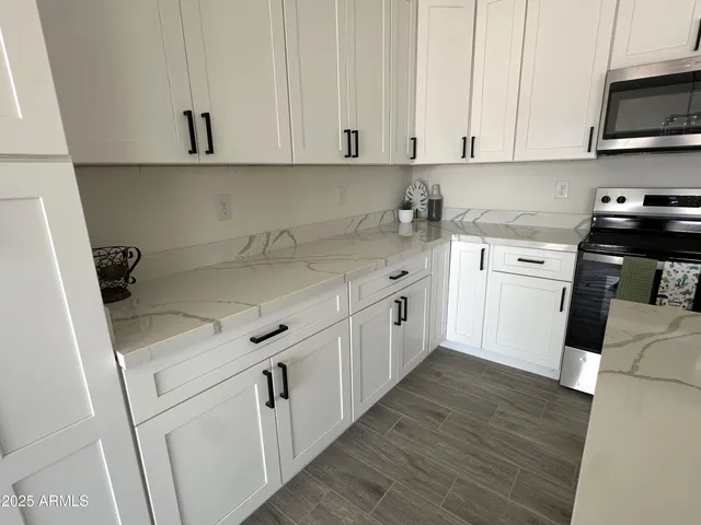 a kitchen with a refrigerator stove and microwave