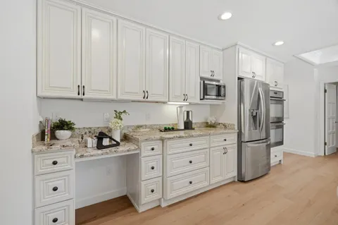 a kitchen with stainless steel appliances a refrigerator sink and cabinets