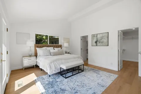 a bed room with a bed and a night stand