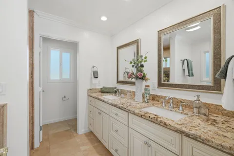a bathroom with double sink and a mirror