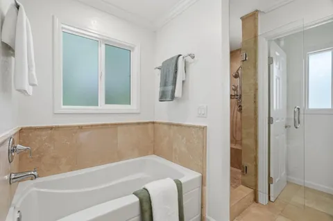 a bathroom with a tub and a shower