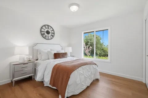 a bedroom with a bed and a window