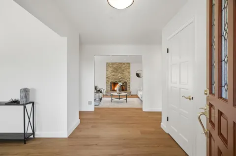 a view of a livingroom with wooden floor and furniture