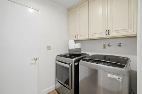a kitchen with granite countertop white cabinets and a stove