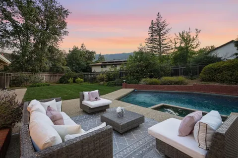 a view of a patio with couches chairs and a fire pit