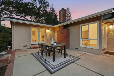 a table and chairs in front of a glass door