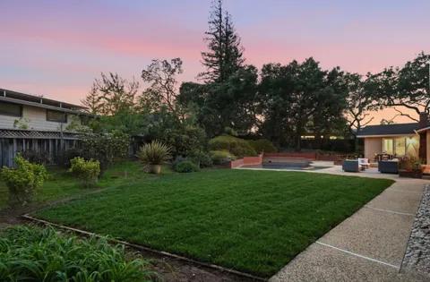 a view of a house with backyard and garden