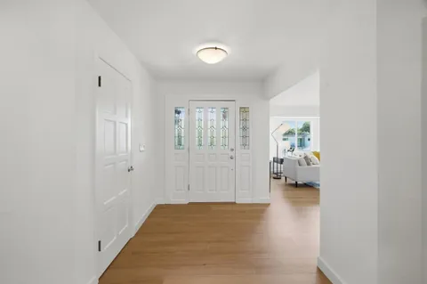 a view of a hallway with a livingroom and a bedroom