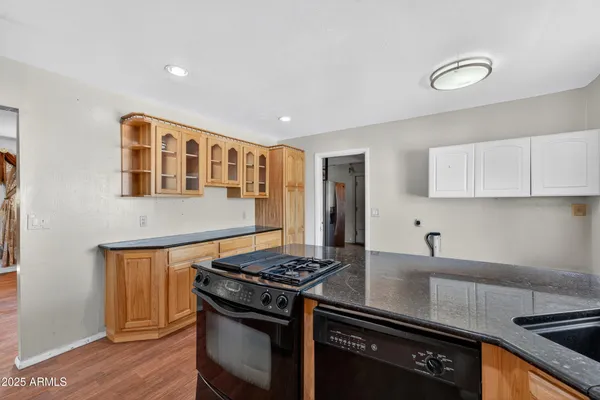 a kitchen with stainless steel appliances granite countertop a stove and a sink