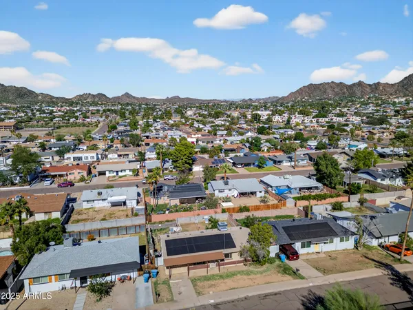 an aerial view of residential houses with city view