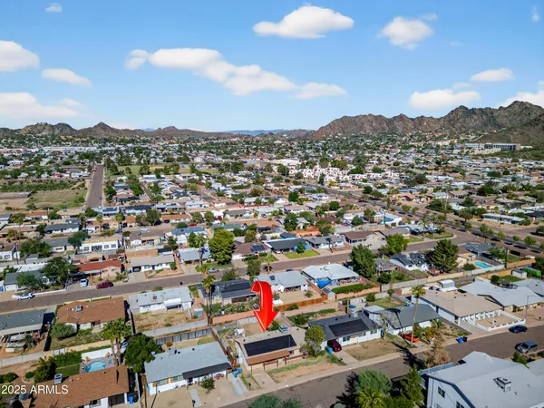 an aerial view of a house with a swimming pool