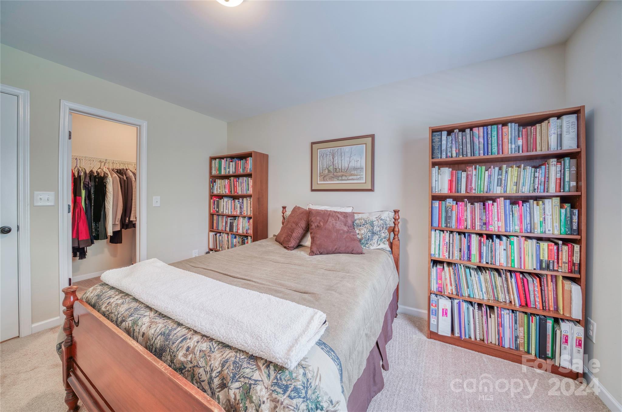 303 Reservation Road Catawba, SC 29704 - Photo 26 of 32 a bedroom with a bed and a book shelf