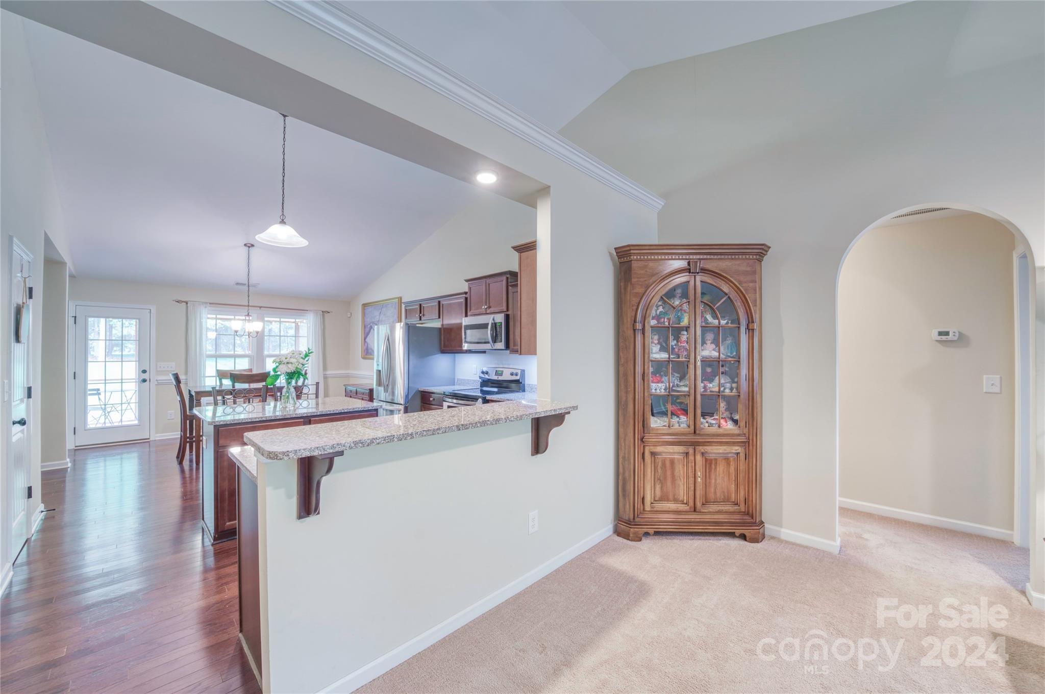 303 Reservation Road Catawba, SC 29704 - Photo 10 of 32 a kitchen with stainless steel appliances granite countertop a refrigerator a stove a sink dishwasher and white cabinets with wooden floor